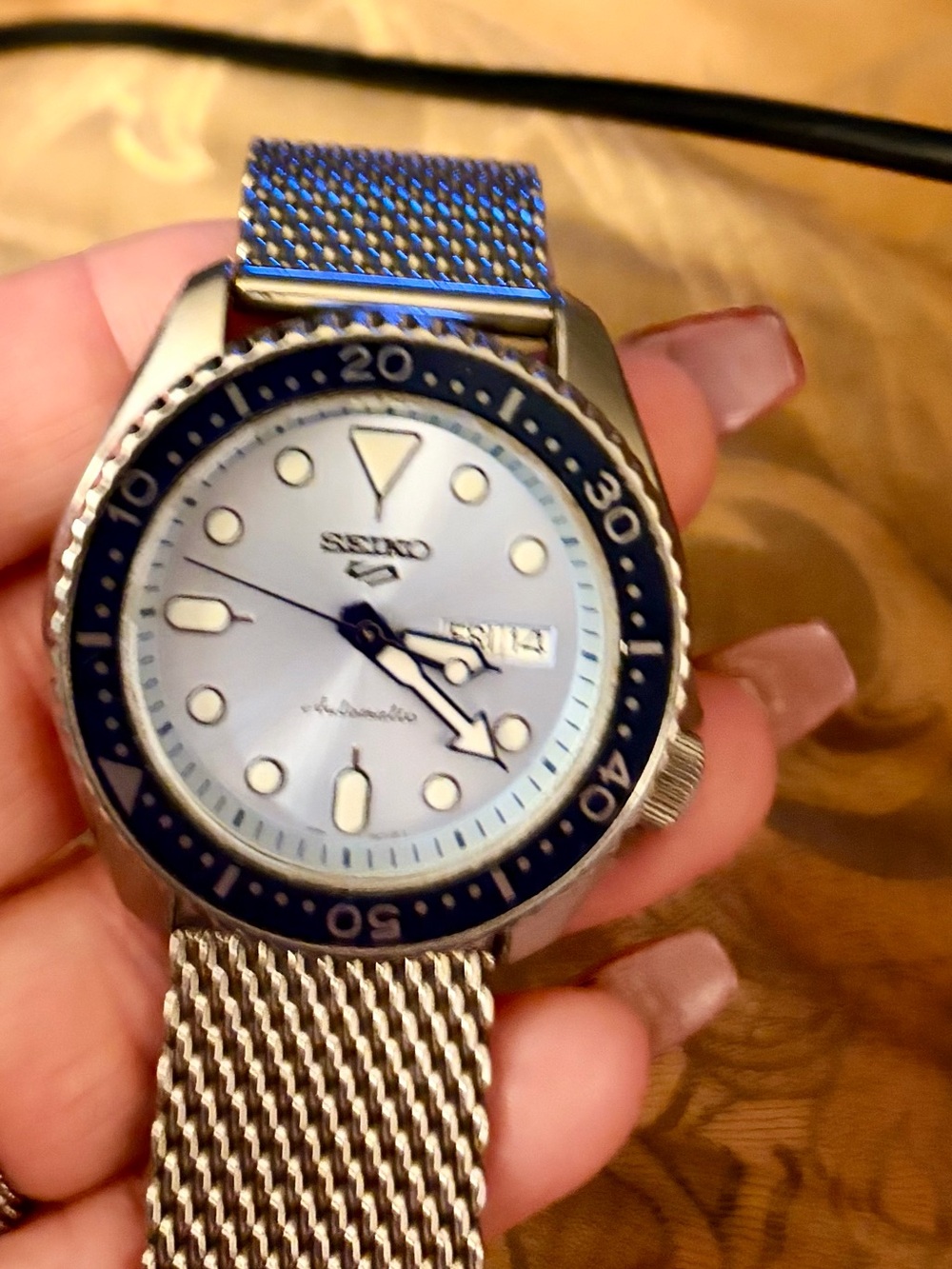 Seiko Silver Watch with Blue Bezel and Mesh Bracelet